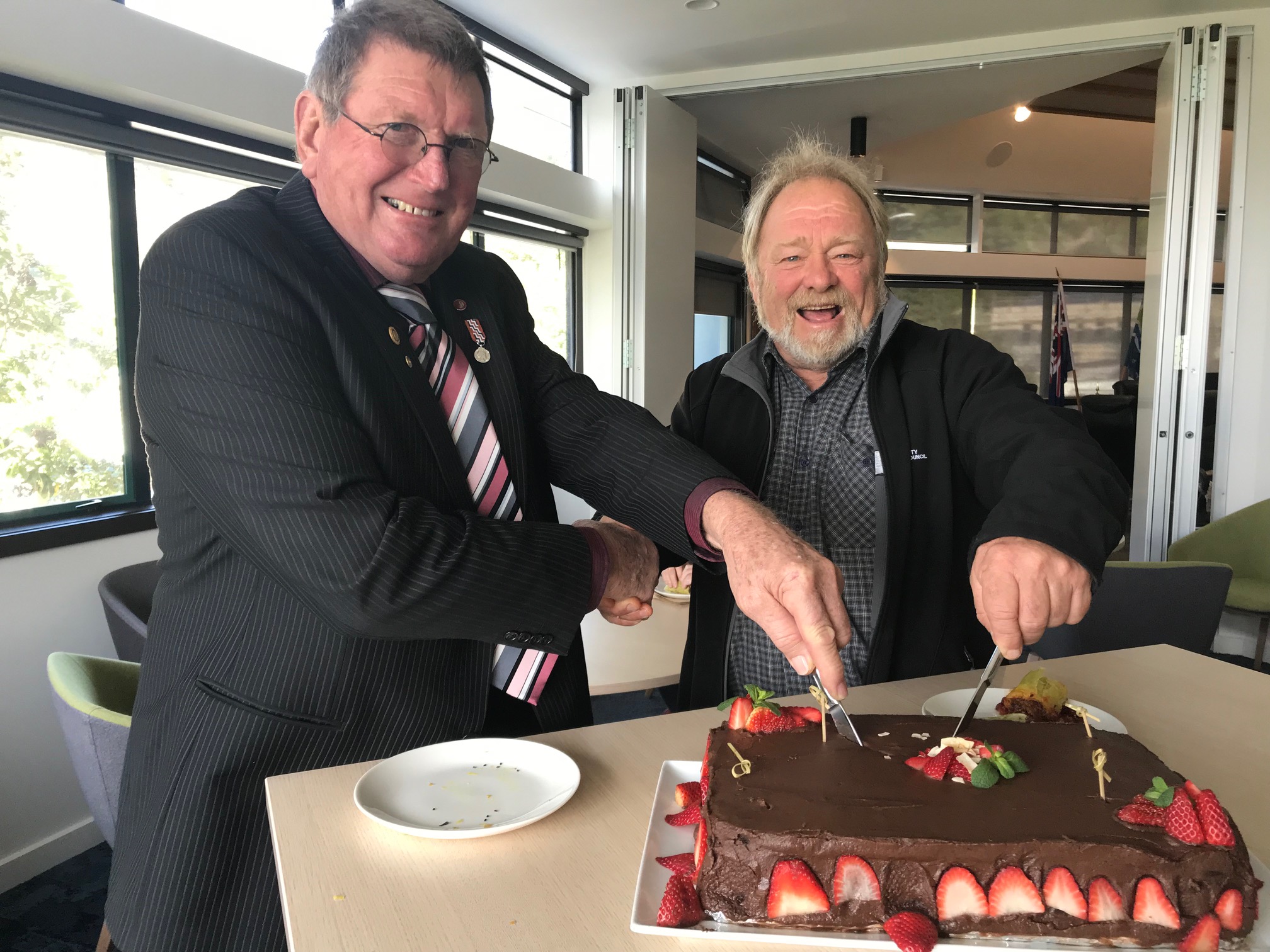 John Pullar (current CLG chair) and Bill Clark (former CLG Chair) cut a cake to say thank you to the Liaison Group for many years of hard work.